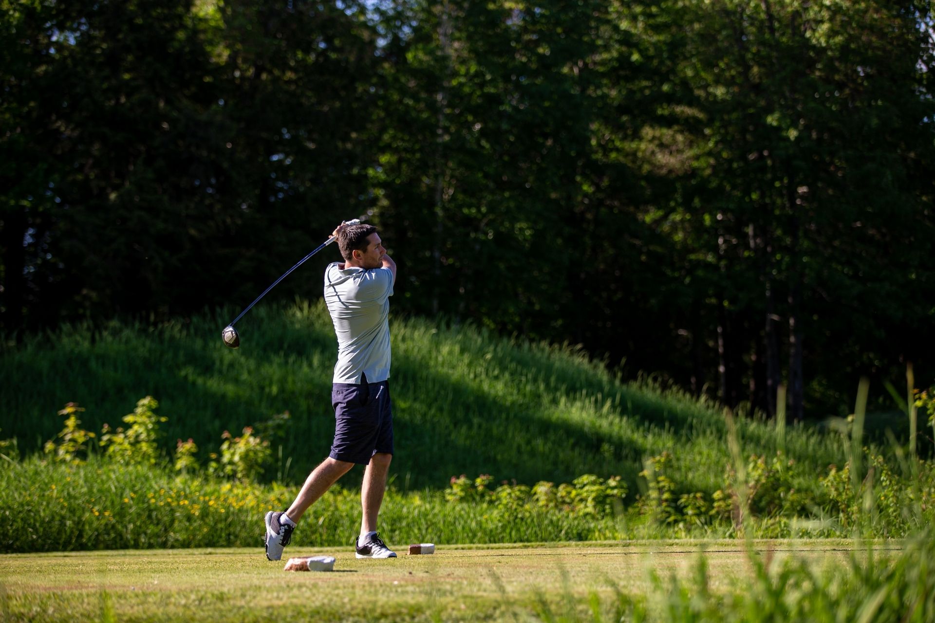 Golfer taking a swing on the course